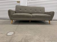 Front view of grey two-seat loveseat showing overall design