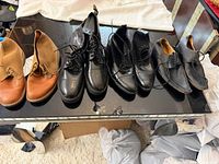 Four pairs of men’s shoes on tabletop