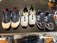 Three pairs of sneakers laid out on table