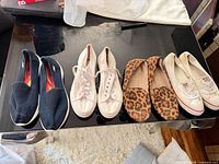 Four pairs of women’s shoes lined side by side on table