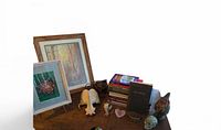 Entire lot on tabletop showing books, prints, bone, figurines, gemstones, cuff