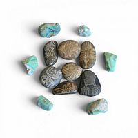 Group view of all carved stones surrounded by turquoise stones