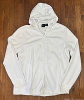 Front view of white Armani Exchange full-zip hoodie laid flat