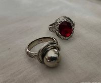 Front view of both sterling rings showing designs and 925 stamp visible on band