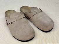 Top view of both taupe suede Birkenstock Boston clogs