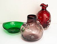 Group shot of green dish, purple vase, red decanter