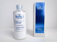 Front view of sealed cleansing water bottle beside sealed emulsion box