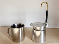 Espresso maker assembled beside matching mug
