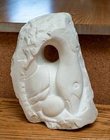 Full view of marble swan relief sculpture showing overall form and rough back