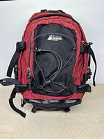 Front view showing logo, red/black colour, bungee cord and zippers