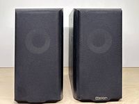 Front view with grilles on showing both speakers