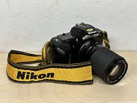 Front angled view of Nikon F-401 with Vivitar lens and strap