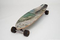 Angled view showing entire longboard, deck graphic, trucks and wheels