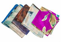 Group of four folded silk scarves