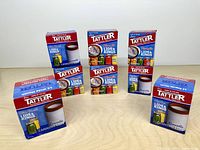 Front view of seven Tattler boxes arranged on table