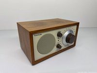Front angled view showing walnut cabinet and control layout