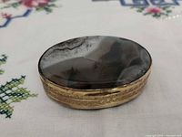 Top view showing banded agate lid and brass body