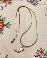 Full view of necklace and pendant laid flat