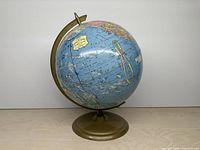 Full view of globe on metal base