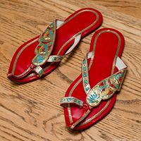 Full view of both red leather sandals