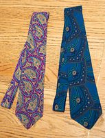 Two silk neckties laid flat showing entire patterns and approximate width