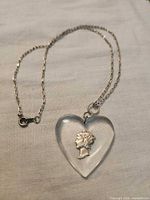 Full view of necklace showing chain and heart pendant