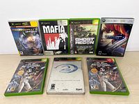 Front view of all seven Xbox game cases showing cover art