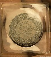 Reverse of 1911 Canadian one cent showing ONE CENT CANADA 1911 within maple leaf wreath