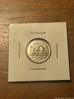 Reverse of 1937 Canadian 5 cent coin in flip