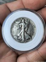 Obverse of 1938 Walking Liberty half dollar in plastic capsule