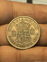 Reverse side of 1948 British half crown coin showing shield design and mint legend
