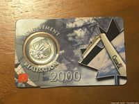 Front of card showing coin and Achievement Réalisation text