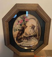 Front view showing framed oval cat plate under glass