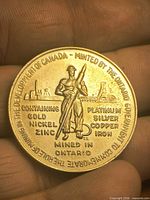 Obverse showing miner, Sudbury mine scene, metal content text and outer legend