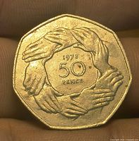 Reverse showing nine clasped hands circle and 1973 50 PENCE legend