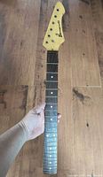 Front view of full guitar neck showing headstock and fingerboard