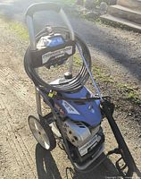 Full view of Yamaha 3100 PSI pressure washer showing frame, hose, wand and wheels