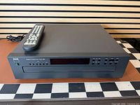 Front view of NAD 523 CD changer with remote on top