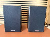 Front view of both Paradigm bookshelf speakers with grilles installed