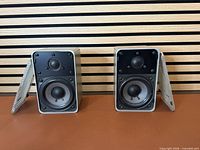 Front view of both Realistic Minimus-7 speakers with grilles off showing drivers