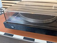 Front corner view showing Dual logo, black plinth, platter edge, dust cover clarity