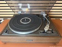 Front view of Pioneer PL-12D turntable with dust cover open showing platter and tonearm