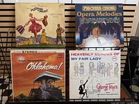 Front covers of four vinyl LPs on display rack