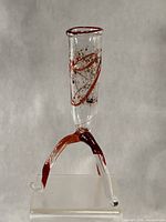 full view showing vase on three legs