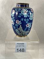 Front view of cobalt blue cloisonné vase with floral design