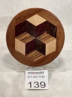 Front view showing full tumbling-block pattern and wood tones