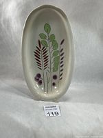Full view of oval ceramic dish with botanical design