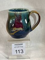 Front view of stoneware mug showing multicolour glaze and shape