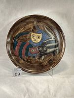 Full view of front of platter showing cat design and brown glaze