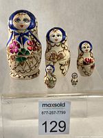 Front view of all five nesting dolls lined up